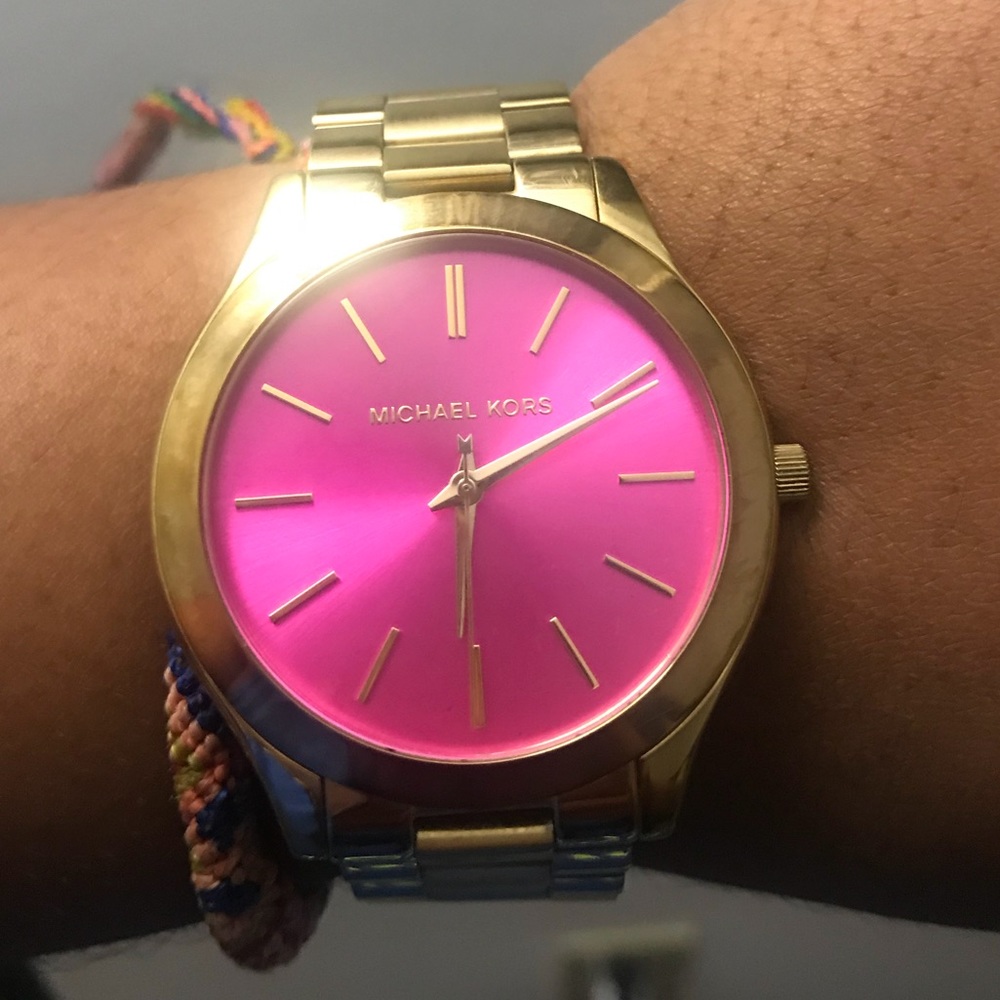 Gold Michael Kors watch with a pink face